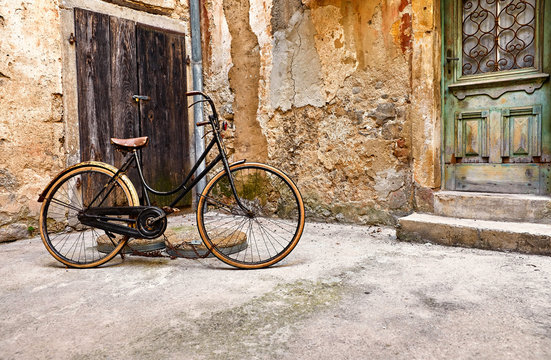 Old retro bicycle on vintage street in Croatia background aged