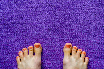 Woman's feet on yoga mat. Top view