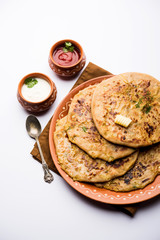 Aloo Paratha / Indian Potato stuffed Flatbread. Served with fresh curd and tomato ketchup. selective focus