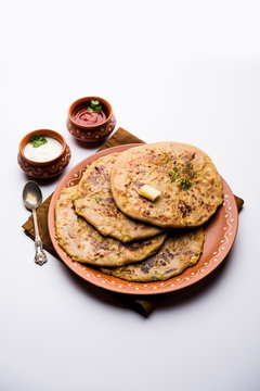 Aloo Paratha / Indian Potato stuffed Flatbread. Served with fresh curd and tomato ketchup. selective focus