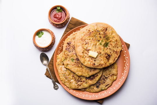 Aloo Paratha / Indian Potato stuffed Flatbread. Served with fresh curd and tomato ketchup. selective focus
