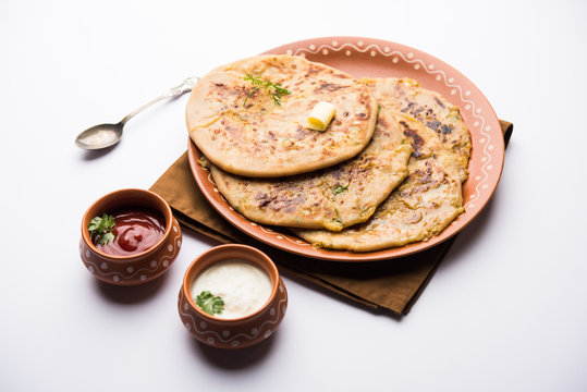 Aloo Paratha / Indian Potato stuffed Flatbread. Served with fresh curd and tomato ketchup. selective focus