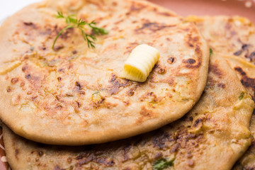Aloo Paratha / Indian Potato stuffed Flatbread. Served with fresh curd and tomato ketchup. selective focus