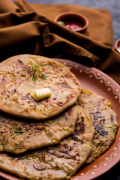 Aloo Paratha / Indian Potato stuffed Flatbread. Served with fresh curd and tomato ketchup. selective focus