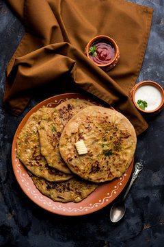 Aloo Paratha / Indian Potato stuffed Flatbread. Served with fresh curd and tomato ketchup. selective focus