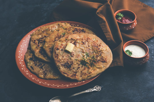Aloo Paratha / Indian Potato stuffed Flatbread. Served with fresh curd and tomato ketchup. selective focus