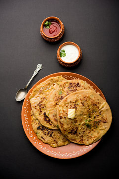 Aloo Paratha / Indian Potato stuffed Flatbread. Served with fresh curd and tomato ketchup. selective focus