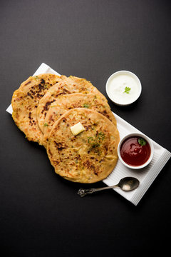 Aloo Paratha / Indian Potato stuffed Flatbread. Served with fresh curd and tomato ketchup. selective focus