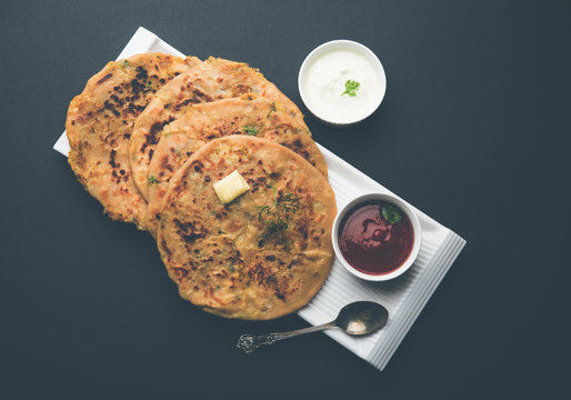 Aloo Paratha / Indian Potato stuffed Flatbread. Served with fresh curd and tomato ketchup. selective focus