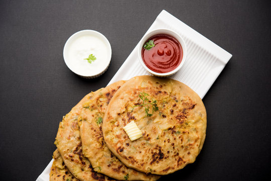 Aloo Paratha / Indian Potato stuffed Flatbread. Served with fresh curd and tomato ketchup. selective focus