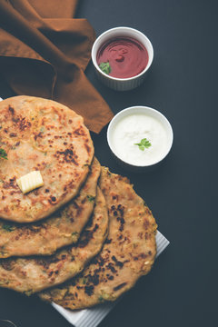 Aloo Paratha / Indian Potato stuffed Flatbread. Served with fresh curd and tomato ketchup. selective focus