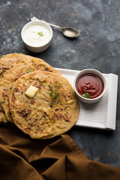 Aloo Paratha / Indian Potato stuffed Flatbread. Served with fresh curd and tomato ketchup. selective focus