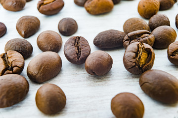 Close Up on Coffee Beans on the white wooden table