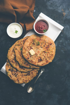 Aloo Paratha / Indian Potato stuffed Flatbread. Served with fresh curd and tomato ketchup. selective focus