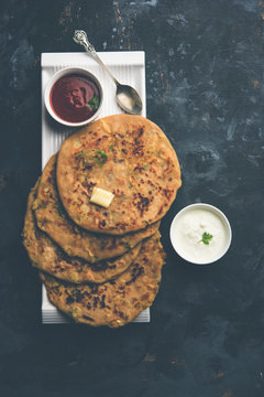 Aloo Paratha / Indian Potato stuffed Flatbread. Served with fresh curd and tomato ketchup. selective focus