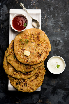 Aloo Paratha / Indian Potato stuffed Flatbread. Served with fresh curd and tomato ketchup. selective focus