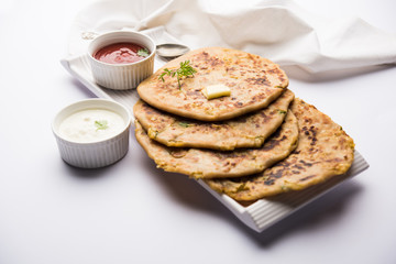 Aloo Paratha / Indian Potato stuffed Flatbread. Served with fresh curd and tomato ketchup. selective focus