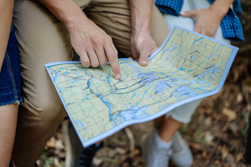 Group of friends watching the route in the traveler map on hiking