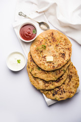 Aloo Paratha / Indian Potato stuffed Flatbread. Served with fresh curd and tomato ketchup. selective focus