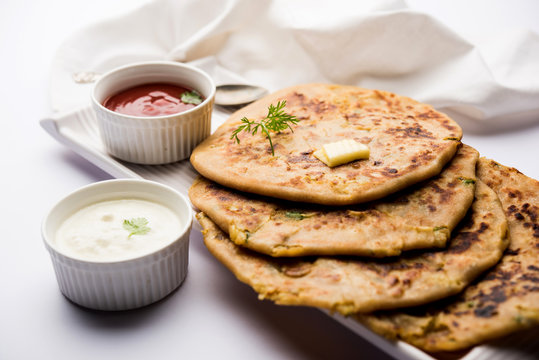 Aloo Paratha / Indian Potato stuffed Flatbread. Served with fresh curd and tomato ketchup. selective focus