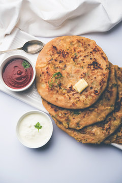 Aloo Paratha / Indian Potato stuffed Flatbread. Served with fresh curd and tomato ketchup. selective focus