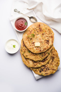 Aloo Paratha / Indian Potato stuffed Flatbread. Served with fresh curd and tomato ketchup. selective focus