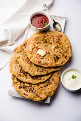 Aloo Paratha / Indian Potato stuffed Flatbread. Served with fresh curd and tomato ketchup. selective focus