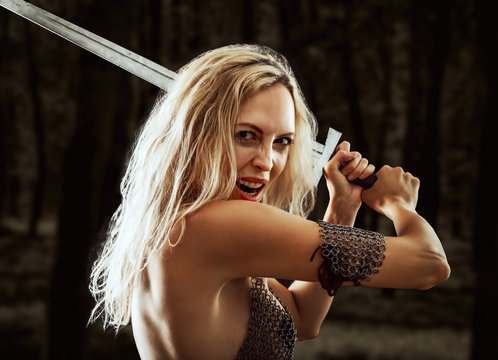 danger sexy warrior viking girl with sword attack