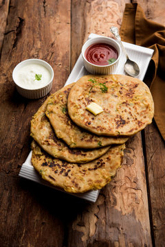 Aloo Paratha / Indian Potato stuffed Flatbread. Served with fresh curd and tomato ketchup. selective focus