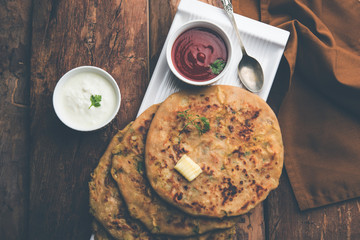 Aloo Paratha / Indian Potato stuffed Flatbread. Served with fresh curd and tomato ketchup. selective focus