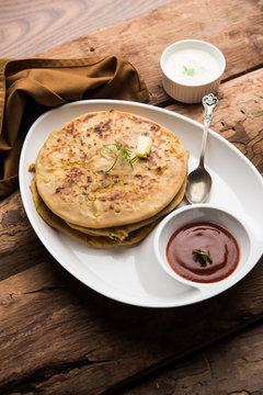 Aloo Paratha / Indian Potato stuffed Flatbread. Served with fresh curd and tomato ketchup. selective focus