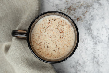 Cup of milk with cinnamon. Top view.