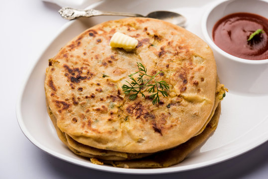Aloo Paratha / Indian Potato stuffed Flatbread. Served with fresh curd and tomato ketchup. selective focus