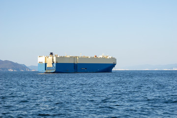 Large White and blue Roll-on/roll-off (RORO or ro-ro) ships or oceangoing vehicle carrier ship...