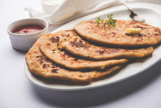 Aloo Paratha / Indian Potato stuffed Flatbread. Served with fresh curd and tomato ketchup. selective focus