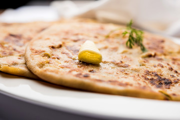Aloo Paratha / Indian Potato stuffed Flatbread. Served with fresh curd and tomato ketchup. selective focus
