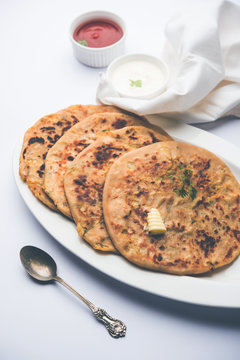 Aloo Paratha / Indian Potato stuffed Flatbread. Served with fresh curd and tomato ketchup. selective focus