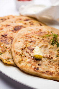Aloo Paratha / Indian Potato stuffed Flatbread. Served with fresh curd and tomato ketchup. selective focus