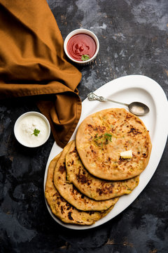 Aloo Paratha / Indian Potato stuffed Flatbread. Served with fresh curd and tomato ketchup. selective focus