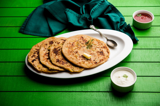 Aloo Paratha / Indian Potato stuffed Flatbread. Served with fresh curd and tomato ketchup. selective focus