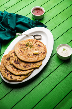 Aloo Paratha / Indian Potato stuffed Flatbread. Served with fresh curd and tomato ketchup. selective focus