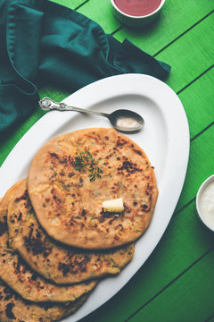 Aloo Paratha / Indian Potato stuffed Flatbread. Served with fresh curd and tomato ketchup. selective focus