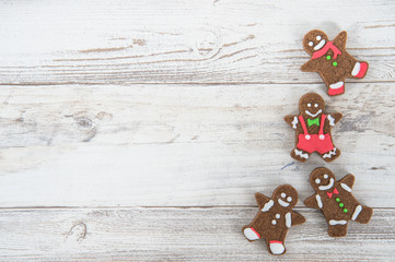 Beautiful Christmas composition and decoration with baked Christmas gingerbread cookies in paper bag on light wooden background, flat lay, top view, copy space (text space)
