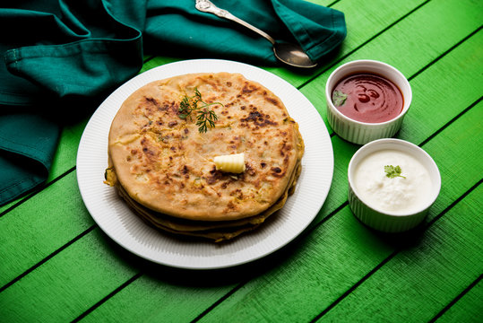 Aloo Paratha / Indian Potato stuffed Flatbread. Served with fresh curd and tomato ketchup. selective focus