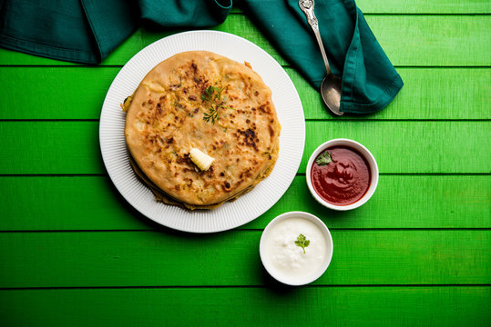 Aloo Paratha / Indian Potato stuffed Flatbread. Served with fresh curd and tomato ketchup. selective focus