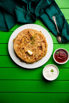 Aloo Paratha / Indian Potato stuffed Flatbread. Served with fresh curd and tomato ketchup. selective focus