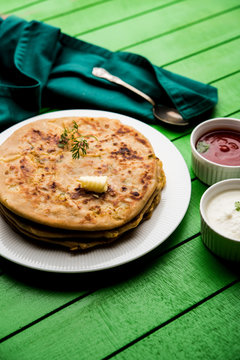 Aloo Paratha / Indian Potato stuffed Flatbread. Served with fresh curd and tomato ketchup. selective focus