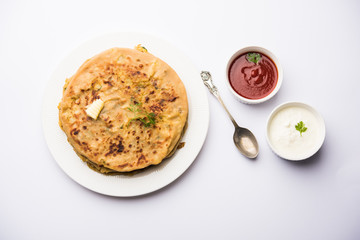 Aloo Paratha / Indian Potato stuffed Flatbread. Served with fresh curd and tomato ketchup. selective focus