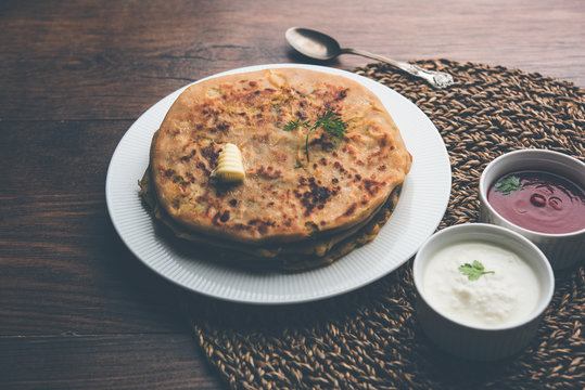 Aloo Paratha / Indian Potato stuffed Flatbread. Served with fresh curd and tomato ketchup. selective focus