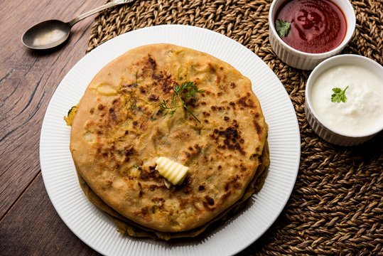 Aloo Paratha / Indian Potato stuffed Flatbread. Served with fresh curd and tomato ketchup. selective focus